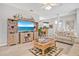 Bright and airy living room with open layout, light wood floors, and entertainment center at 651 Back Nine Dr, Venice, FL 34285