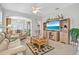 Bright and airy living room featuring an open layout, wood floors, and custom built-in shelving at 651 Back Nine Dr, Venice, FL 34285