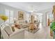 Bright living room with white sofas, plantation shutters, light wood flooring, and an open layout at 651 Back Nine Dr, Venice, FL 34285