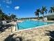 Resort-style pool with clear blue water, framed by palm trees and lounge chairs for a relaxing and refreshing experience at 651 Back Nine Dr, Venice, FL 34285