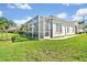 Relax on the screened lanai of this beautifully landscaped home, set on a lush green lawn at 651 Back Nine Dr, Venice, FL 34285