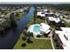 Scenic aerial view of residential community with a pool next to a serene canal at 66 Boundary Blvd # 275, Rotonda West, FL 33947