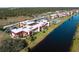 Aerial view of condo complex near the water and surrounded by trees at 66 Boundary Blvd # 275, Rotonda West, FL 33947