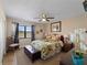 Cozy bedroom with natural light, ceiling fan, and tropical-themed decor at 66 Boundary Blvd # 275, Rotonda West, FL 33947