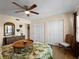Comfortable bedroom featuring a ceiling fan, natural lighting, and ample closet space at 66 Boundary Blvd # 275, Rotonda West, FL 33947