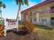 Condo complex exterior featuring well-maintained landscaping, architectural details, and unit signage at 66 Boundary Blvd # 275, Rotonda West, FL 33947