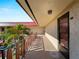 Hallway featuring the unit's door, potted plants, and a railing with a view of the courtyard at 66 Boundary Blvd # 275, Rotonda West, FL 33947