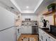 Bright kitchen featuring white cabinetry, stainless steel appliances, and modern fixtures at 66 Boundary Blvd # 275, Rotonda West, FL 33947