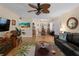 Inviting living room with herringbone floors and a tropical-themed rug at 66 Boundary Blvd # 275, Rotonda West, FL 33947