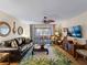 Cozy living room with a comfortable couch and screened-in lanai at 66 Boundary Blvd # 275, Rotonda West, FL 33947