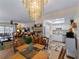 Open-concept living and dining area with chandelier lighting and easy access to the kitchen at 66 Boundary Blvd # 275, Rotonda West, FL 33947