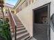 Exterior stairway leading to apartments, showcasing the building's architecture and lush landscaping at 66 Boundary Blvd # 275, Rotonda West, FL 33947
