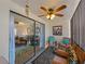 Enclosed sunroom featuring comfortable seating, ceiling fan, and sliding glass doors to living area at 66 Boundary Blvd # 275, Rotonda West, FL 33947