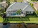 Aerial shot of the screened-in lanai with pool, overlooking a serene pond and manicured landscaping at 692 Egret Walk Ln, Venice, FL 34292