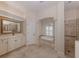 Well-lit bathroom featuring a tub beneath an arched window, a shower, and a vanity at 692 Egret Walk Ln, Venice, FL 34292