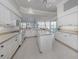 Bright kitchen with island, white appliances and access to outdoor dining area at 692 Egret Walk Ln, Venice, FL 34292