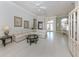 Open concept living room with tile floors and lots of natural light at 692 Egret Walk Ln, Venice, FL 34292