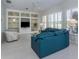 Cozy living room features built-in shelves, a ceiling fan, and large windows at 692 Egret Walk Ln, Venice, FL 34292