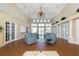 Spacious lounge area with high ceilings, a chandelier, comfortable seating and abundant natural light at 692 Egret Walk Ln, Venice, FL 34292