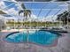 Screened-in pool and jacuzzi overlooking the water and nature preserve at 692 Egret Walk Ln, Venice, FL 34292