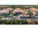 Aerial view of the home with parking and surrounding trees at 7104 L Pavia Blvd # 7104, Venice, FL 34292
