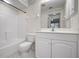 Bathroom features a shower, toilet, and cabinet at 7104 L Pavia Blvd # 7104, Venice, FL 34292