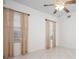 Bright bedroom with two windows and light-colored neutral drapes and a ceiling fan at 7104 L Pavia Blvd # 7104, Venice, FL 34292