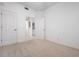 Empty bedroom with neutral carpet and three doors at 7104 L Pavia Blvd # 7104, Venice, FL 34292