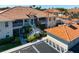 Exterior view of building with a red tile roof and staircase at 7104 L Pavia Blvd # 7104, Venice, FL 34292