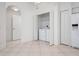 Bright laundry area featuring tiled flooring, a ceiling fan, and a utility closet with a washer and dryer at 7104 L Pavia Blvd # 7104, Venice, FL 34292