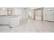 An open living area features bright natural light, tile floors and a view into other rooms of the home at 7104 L Pavia Blvd # 7104, Venice, FL 34292