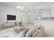 Bright living room with tile floors, modern lighting and adjacent kitchen at 7104 L Pavia Blvd # 7104, Venice, FL 34292