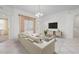 Bright living room with a soft sectional, tv, tile floors, and curtains at 7104 L Pavia Blvd # 7104, Venice, FL 34292