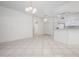 Bright living room with tile floors, modern lighting and adjacent kitchen at 7104 L Pavia Blvd # 7104, Venice, FL 34292