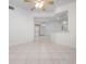 Open floor plan features neutral tile flooring, abundant natural light and ceiling fan at 7104 L Pavia Blvd # 7104, Venice, FL 34292