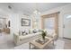 Bright living room with neutral decor, tile floors, and a cozy sectional at 7104 L Pavia Blvd # 7104, Venice, FL 34292