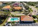 Community pool and clubhouse aerial view featuring a pool, lounge chairs, and lush landscaping at 7104 L Pavia Blvd # 7104, Venice, FL 34292
