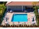 Relaxing community pool with lounge chairs, umbrellas, and well-maintained landscaping at 7104 L Pavia Blvd # 7104, Venice, FL 34292