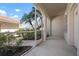 A screened in porch showing the manicured landscape and tiled concrete floor at 7104 L Pavia Blvd # 7104, Venice, FL 34292
