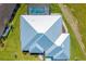 Bird's eye view of modern home with a geometric roof design, a pool, and lush landscaping at 7407 S Blue Sage, Punta Gorda, FL 33955