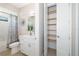 Bright bathroom featuring a shower, toilet and walk-in closet with shelving at 7407 S Blue Sage, Punta Gorda, FL 33955