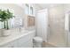 Bright bathroom featuring a white vanity, toilet, and tiled shower at 7407 S Blue Sage, Punta Gorda, FL 33955