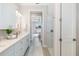 Bathroom with double vanity, modern fixtures, walk-in shower and view to main bedroom at 7407 S Blue Sage, Punta Gorda, FL 33955