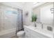 Bright bathroom with marble-look shower, bathtub, and dual vanity at 7407 S Blue Sage, Punta Gorda, FL 33955