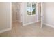 Bright bedroom with ensuite bath, light tile floors, and view of pool area at 7407 S Blue Sage, Punta Gorda, FL 33955