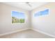 Bright bedroom featuring neutral colors, baseboard trim and two large windows at 7407 S Blue Sage, Punta Gorda, FL 33955