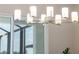 A modern chandelier is hanging near big windows, offering a view of the outdoors at 7407 S Blue Sage, Punta Gorda, FL 33955