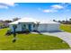 Beautiful single-story home featuring manicured landscaping and a well-maintained lawn at 7407 S Blue Sage, Punta Gorda, FL 33955