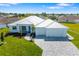 A charming single Gathering home with a well-maintained lawn and a light gray brick driveway and modern, sleek design at 7407 S Blue Sage, Punta Gorda, FL 33955