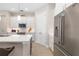 An open kitchen features white cabinets, stainless steel appliances, and an island with modern countertops at 7407 S Blue Sage, Punta Gorda, FL 33955